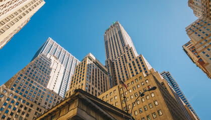 Giant skyscrapers dominate city streets of Wall Street. Lower Manhattan, New York City