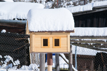 A bunch of snow on a bird house