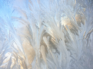 frosty patterns on the window glass closeup. natural textures and backgrounds. ice patterns on frozen