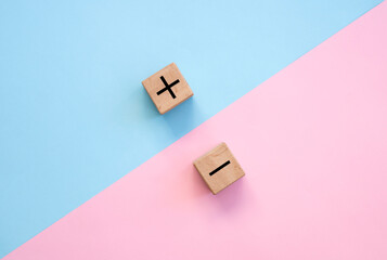 Plus and minus signs on a multi-colored background. Positive and negative information