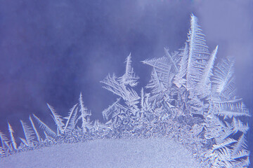 frosty patterns on the window glass closeup. natural textures and backgrounds. ice patterns on frozen