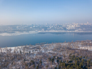 Melting Dnieper River in spring Kiev. Ice crack on the river. Aerial drone view. Spring sunny morning.