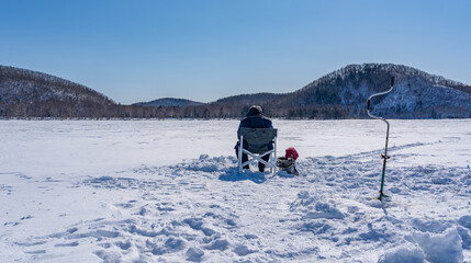 People catch fish on a frozen lake. Winter fishing