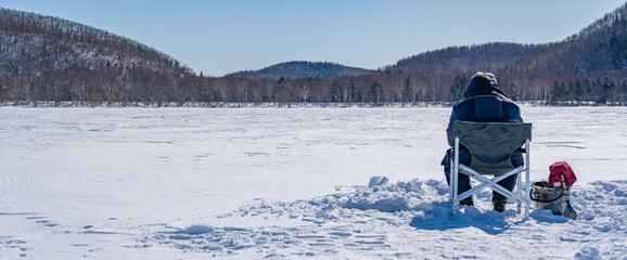 People catch fish on a frozen lake. Winter fishing