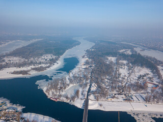 Melting Dnieper River in spring Kiev. Ice crack on the river. Aerial drone view. Spring sunny morning.