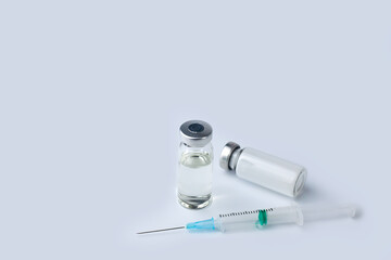 Vaccine vial, medicine drug bottles and syringe injection on a white background. Vaccination,...