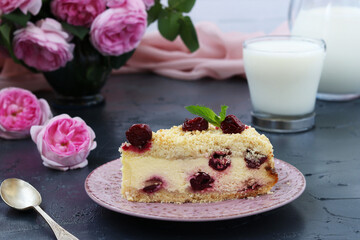 Piece of cottage cheese cake with cherries on a dark background and jug with milk. Close up