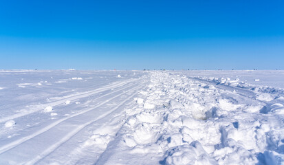 Fototapeta na wymiar road on the frozen sea made by fishermen