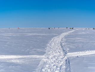 Fototapeta na wymiar road on the frozen sea made by fishermen