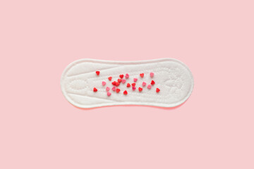 Feminine hygiene photo. Menstrual woman pads for hygiene protection in critical days, cycle blood period concept. Menstruation sanitary and gynecological soft pad with hearts on it. Flat lay, top view © makanna