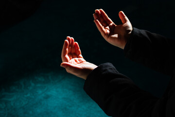 Praying man's hands illuminated by sunlight. eid mubarak, islamic new year, Ramadan and kandil...