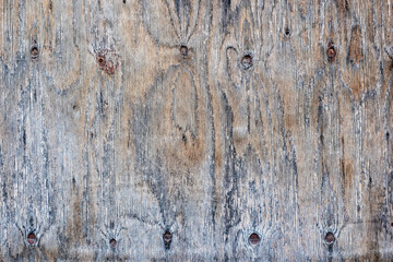 Surface of old plywood with knots, gray spots