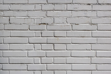 Classic surface of white obsolete bricks, worn