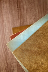 Stack of beautiful vintage books on wooden background. Top view.
