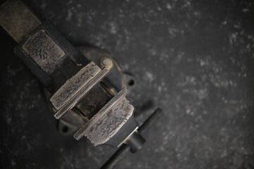 Black vise On a gray blurry background. Top view. Selective soft focus