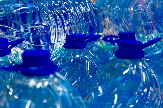 Large bottles of 5 liters of water. Detail of stack bottled water in the store. Selective focus
