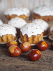 Homemade Easter cakes with eggs on a wooden background.The idea of preparing for the Easter holiday.