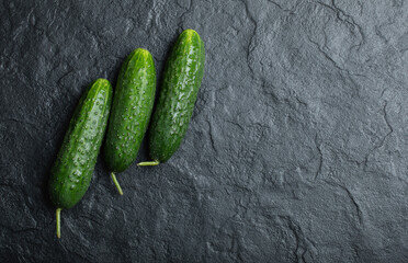 Three fresh cucumber on black background. Fresh organic vegetable