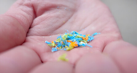 Side View Of a Person Holding Micro Plastics In His Hand. Non-Recyclable Materials. Selective Focus With Shallow Depth Of Field. Holding Microplastics From The Sand On The Beach.