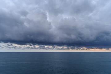 Cumulus clouds hovering over the Ligurian sea, Italy