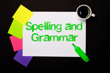 A sheet of paper with the SPELLING AND GRAMMAR, a cup of coffee, bright multi-colored stickers for...