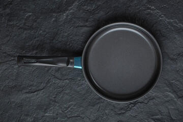 Empty frying pan for cooking placed on black background