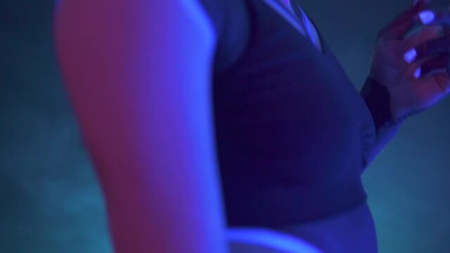 Portrait of a Girl with Dreadlocks in Neon UF Light. Model Girl with Fluorescent Creative Psychedelic MakeUp, Art Design of Female Disco Dancer Model in UV, Colorful Abstract Make-Up. Dancing Lady