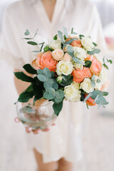 Beautiful modern wedding bouquet in the hands of the bride.
