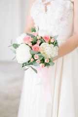 Beautiful modern wedding bouquet in the hands of the bride.