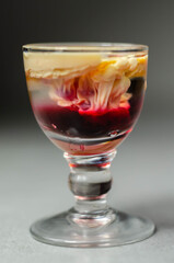 Interesting drink shot based on cream, liqueur and grenadine called Brain Hemorrhage prepared for Halloween party