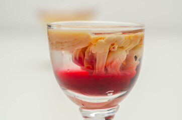 Interesting drink shot based on cream, liqueur and grenadine called Brain Hemorrhage prepared for Halloween party