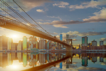 New York City Panoramic landscape view of Manhattan with famous Brooklyn Bridge at dusk .