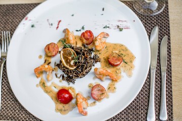 Serving of grilled Mediterranean prawns on a white plate.