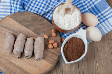 Cocoa wrap mutaki cookies on a wooden board with cinnamon and nuts
