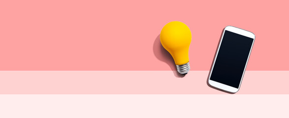Smartphone with a yellow light bulb from above © Tierney