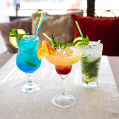 Blue, Mojito and orange alcoholic cocktails