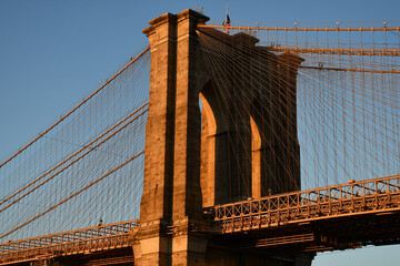 A tower of the Brooklyn Bridge during golden hour