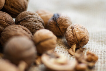 Walnut kernels and whole walnuts on a rustic old oak table.