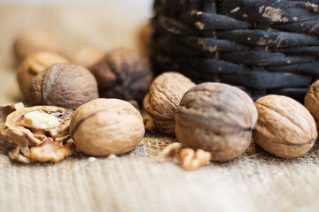Walnut kernels on a dark table with a colored background