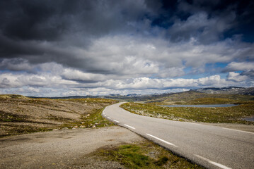 Empty road. road to clouds. rocky road goes into the distance into the blue sky.  Beautiful Norway landscape, Travel in Norway