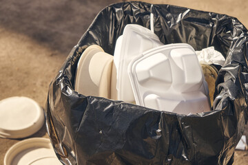 Food to go. Disposable food container in  garbage bin.  Overflowing garbage bin. Environmental pollution.