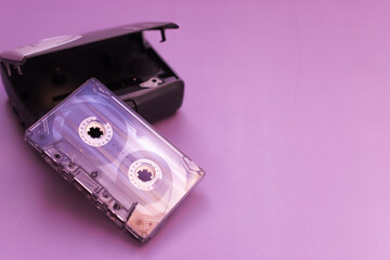 Man has nostalgia and rewinds and winds cassette tape in stereo cassette player with headphones.