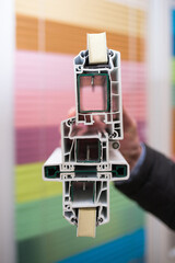 sectional metal-plastic structures, energy-saving technologies. in men's hands a sample of the construction of a metal-plastic balcony in section.