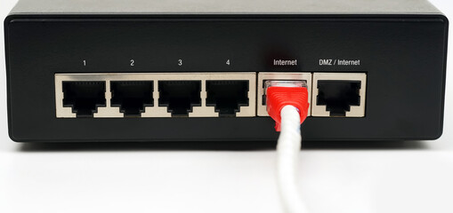 Person plugging in cable to wireless router. Close up.