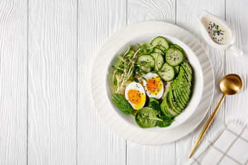 bowl with quinoa, greens, avocado and boiled egg