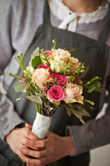 Wedding bouquet of various flowers in hand