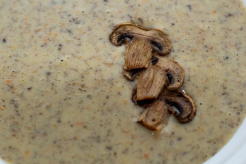 Aromatic mushroom cream soup with champignons. Fresh vegetables and freshly baked bread. A hearty and delicious lunch.