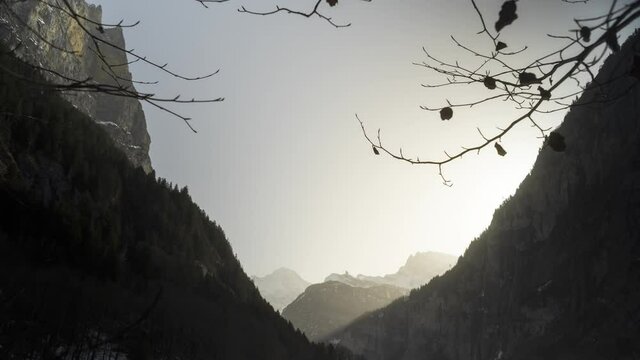Lauterbrunnen Sunset with Sahara Dust and Branches in front Time Lapse