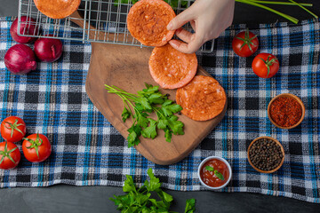 Grilled Salami slices on wooden board with fresh vegetables