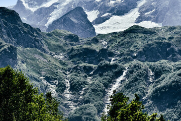 Large and small rivers and waterfalls in North Ossetia against the backdrop of majestic mountains....
